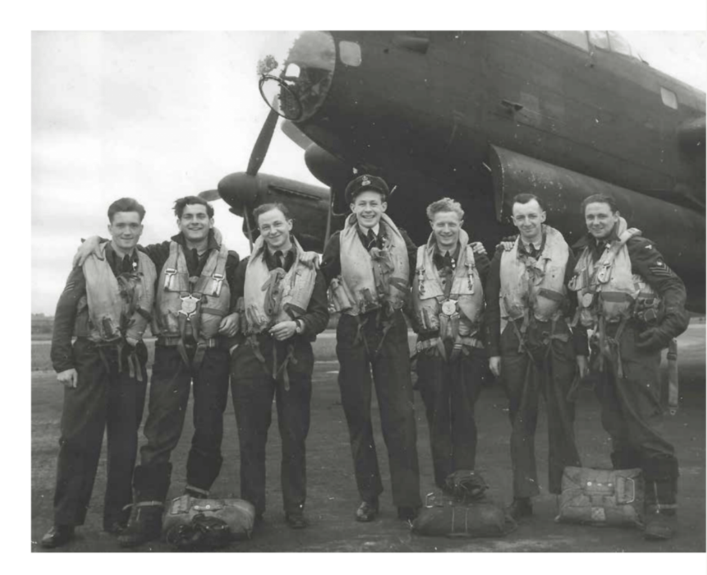 Black and white photo of a Lancaster Bomber Crew and the nose of the plane