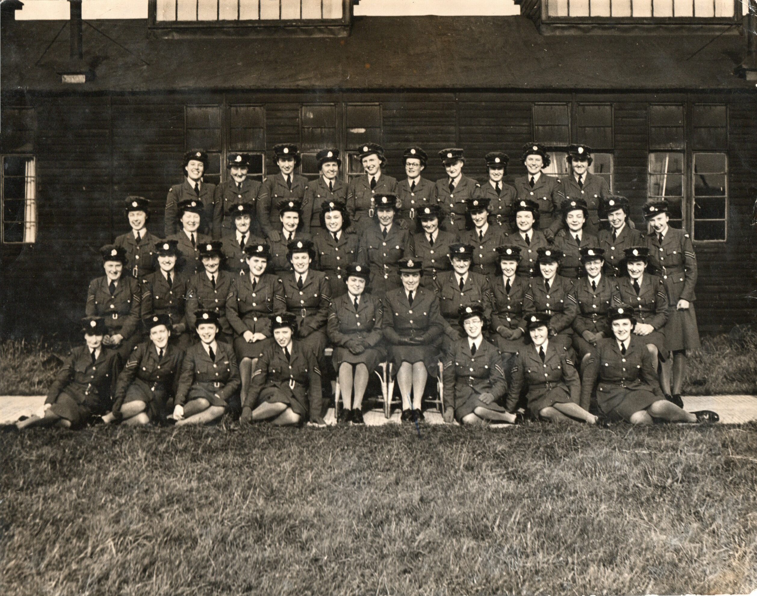 Corporal Lin Price is featured in a Black and white photo of a group of WAAF personnel