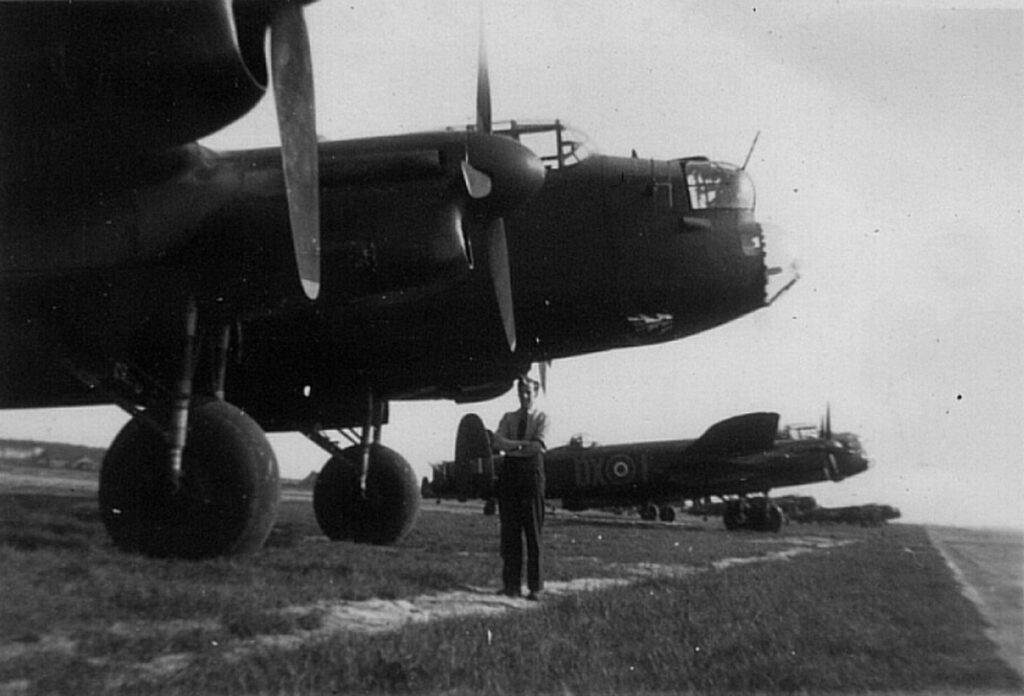 Black and white photo of Lancaster and crewman - Op Exodus