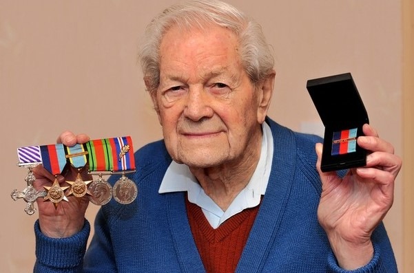 colour photo of Alan Castle with medals